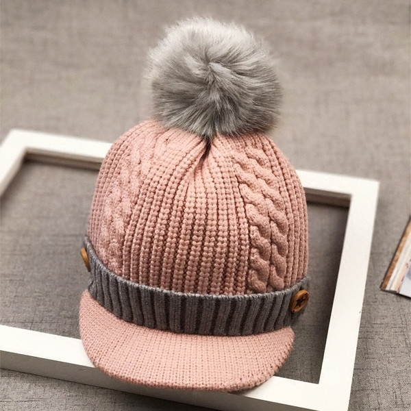 Зимна детска шапка с козирка и пухче в няколко цвята