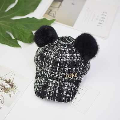 Вълнена детска шапка с козирка и пухчета,с метален надпис