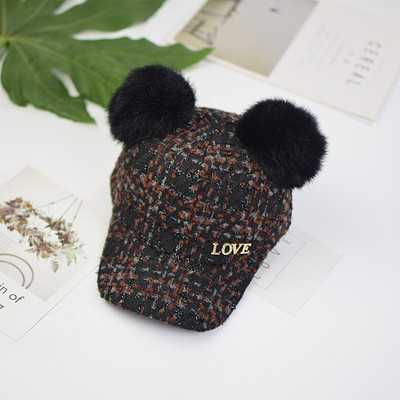 Вълнена детска шапка с козирка и пухчета,с метален надпис