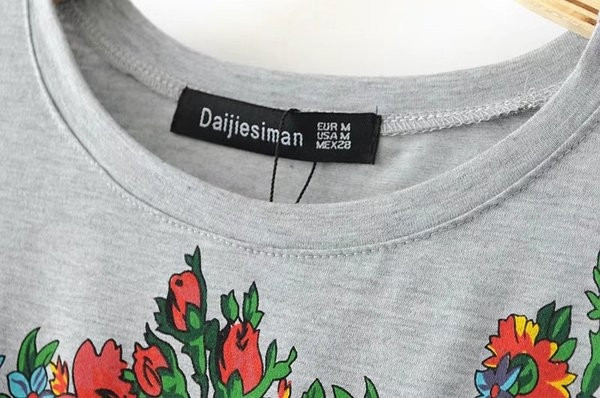 Περιστασιακή γυναικεία μπλούζα με κρεμαστά σκελίδες, floral κεντήματα και κοντά μανίκια