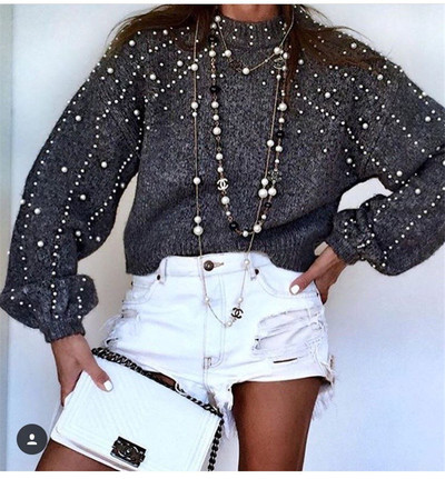 Women`s wide sweater with bead decoration