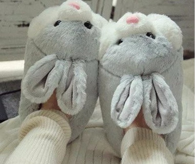 Homemade women`s down slippers imitating a rabbit