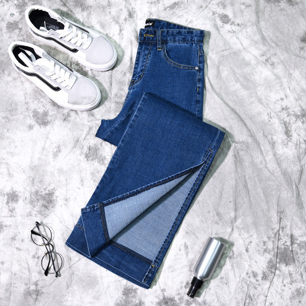 Γυναικεία τζιν σε ένα ευρύ σχέδιο με σχισμή σε σκούρο χρώμα