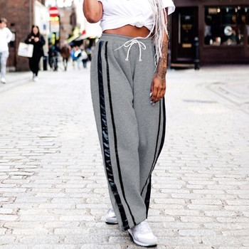 Спортен дамски панталон в свободен стил в сив цвят с кант