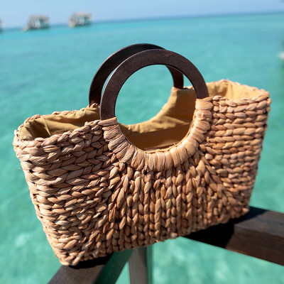 Women`s knitted bag suitable for a beach with round handles