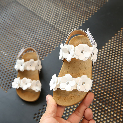 Stylish children`s sandals with a floral motif for girls in white pink color