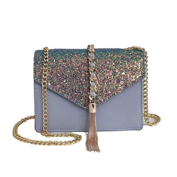 Κομψή γυναικεία τσάντα με πέτρινη διακόσμηση και φούντα με μεταλλική λαβή