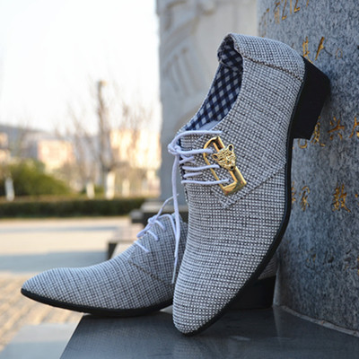 Extravagant men`s shoes made of fabric is metal elements