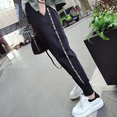 Women`s sports pants in black with various inscriptions