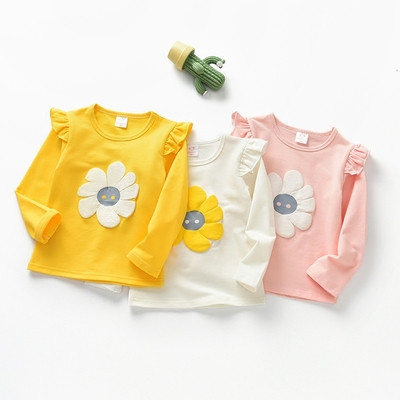 Casual children`s blouse with long sleeves for girls with a floral motif in three colors