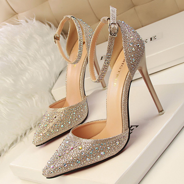 Elegant women`s closed sandals on high thin heel with decorative stones