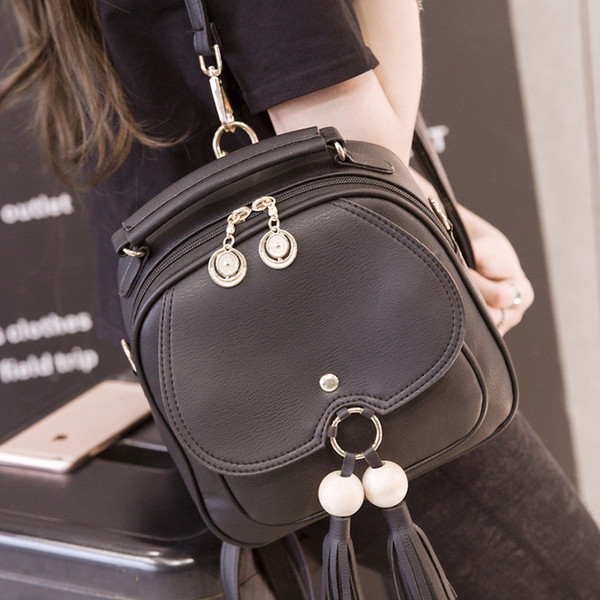 Elegáns női hátizsák két színben fém elemekkel és bojttal