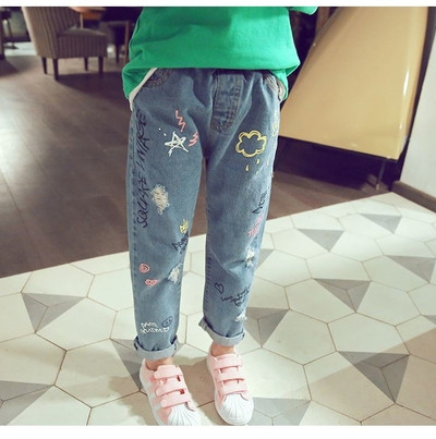 Casual children`s jeans for girls with colorful mini applications in light color