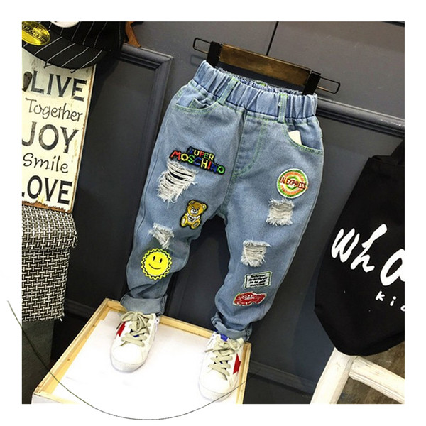 Blugi unisex moderni pentru copii cu mini imprimeuri color și petice în culori deschise