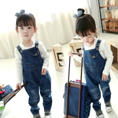 Children`s denim overalls for girls with a decorated front pocket