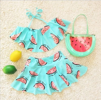 Children`s swimsuit for girls in two parts - skirt and bustier, with print
