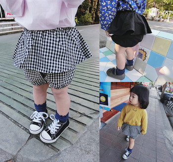 Μοντέρνα παιδικί φούστα για τα κορίτσια σε δύο χρώματα - μαύρο και καρό