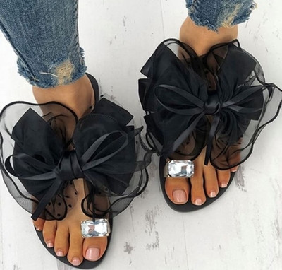 Casual women`s slippers with a very beautiful ribbon and a shiny stone imitating a diamond