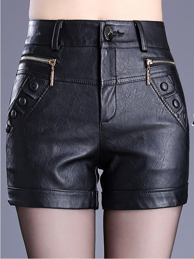 Black women`s shorts made of eco leather with decoration zippers and buttons