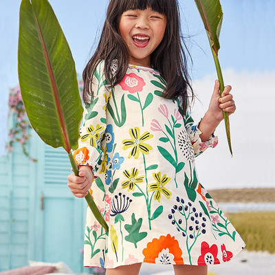 Children`s dress in floral motifs suitable for the beach