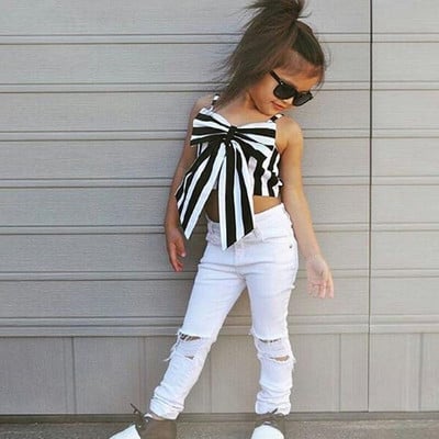 Children`s stylish set - tank top with ribbon and jeans with torn motifs