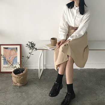 Κομψή γυναικεία φούστα με ασύμμετρο μήκος και διακοσμητικά κουμπιά σε δύο χρώματα