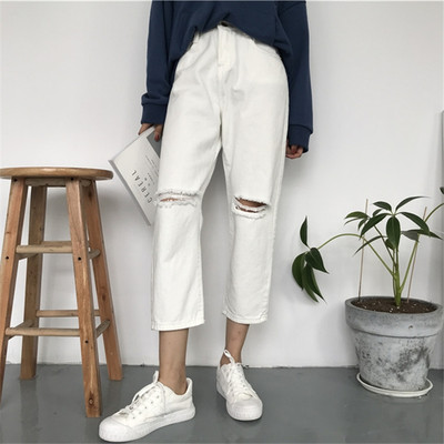 Long women`s jeans with a torn motif in white and black