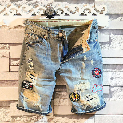 Men`s spectacularly torn jeans with appliques