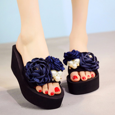 Γυναικείες παντόφλες με μαύρο χρώμα σε μια πλατφόρμα με floral διακόσμηση