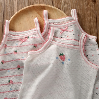 Children`s set of three tank tops for a girl in white with decoration