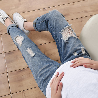 Modern jeans for pregnant women with torn motifs