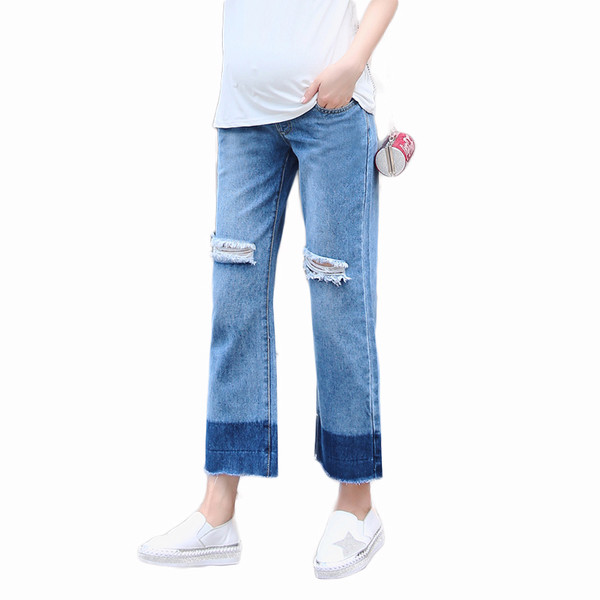 Blugi de dama pentru gravide cu motive rupte intr-un model larg