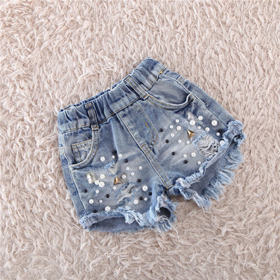 Παιδικά παντελόνια  denim με σκισμένα μοτίβα και  με μταλλική διακόσμηση
