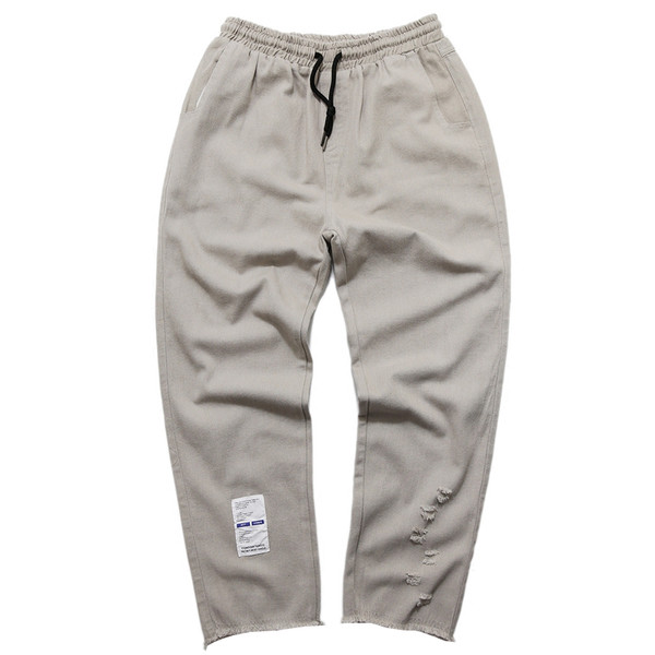 Παντελόνια ανδρικά με τυπωμένα και σκισμένα μοτίβα σε μαύρο και μπεζ χρώμα