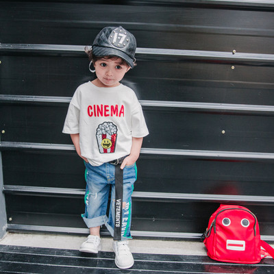 Παιδική βαμβακερή μπλούζα με εφαρμογές και σχισμένα σχέδια σε λευκό και μαύρο χρώμα