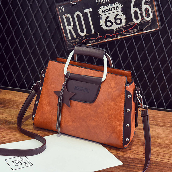 Κυρίες κομψή δερμάτινη τσάντα με μεταλλικά στοιχεία και μενταγιόν