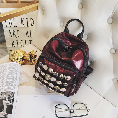 Модерна дамска раница с лъскаво покритие и метална декорация в няколко цвята