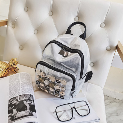 Модерна дамска раница с лъскаво покритие и метална декорация в няколко цвята